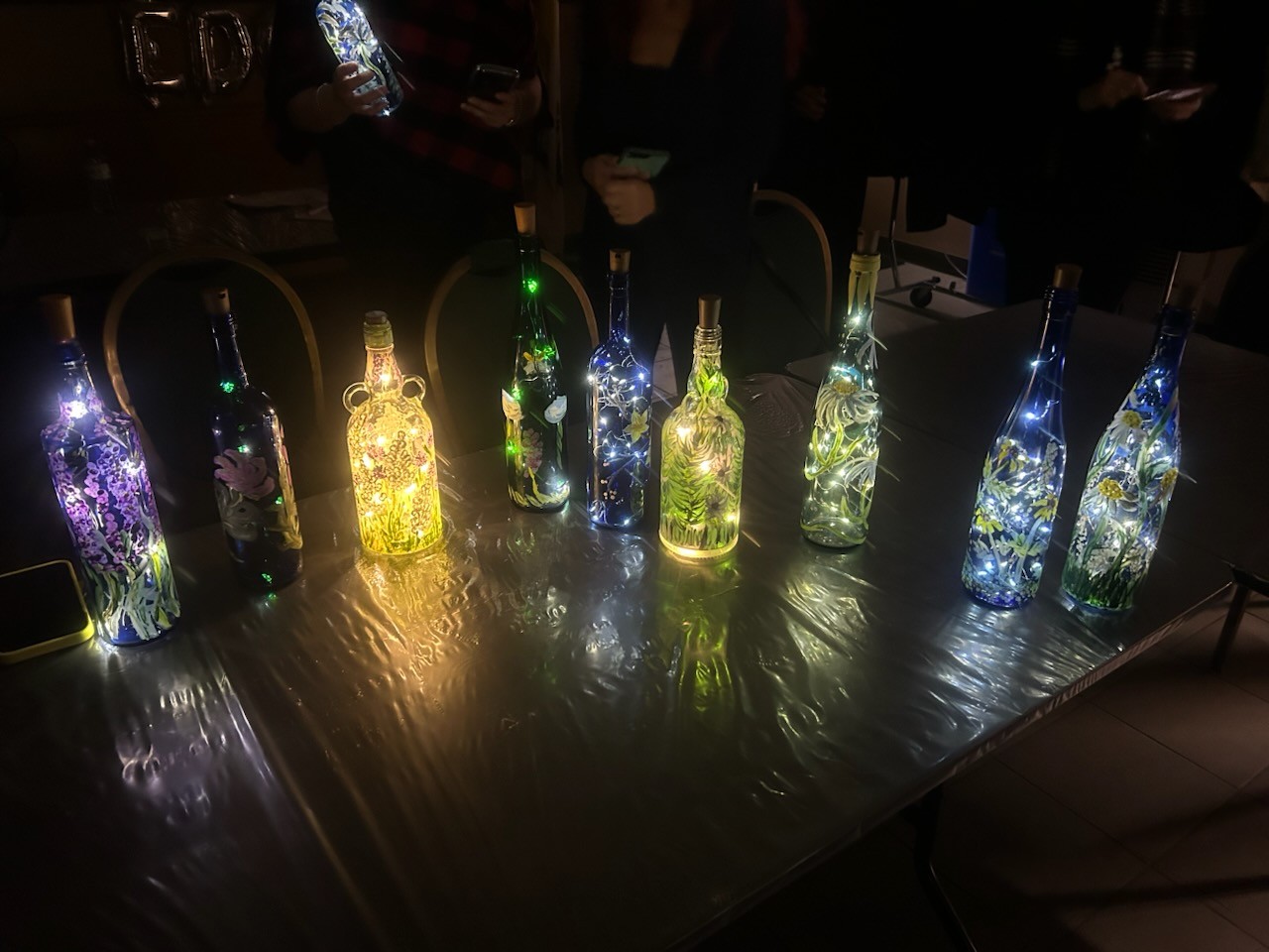 one set of blue bottles painted in various designs with lights