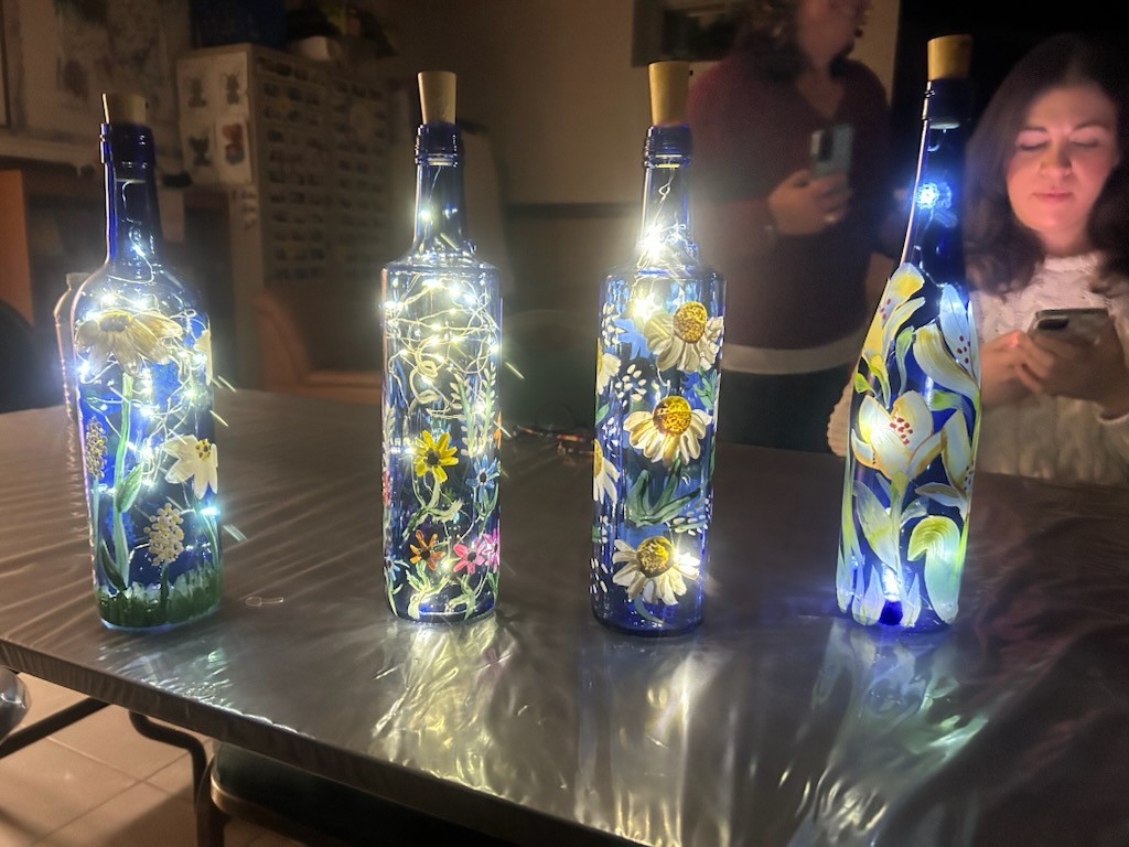 Second set of blue painted bottles in various designs with lights