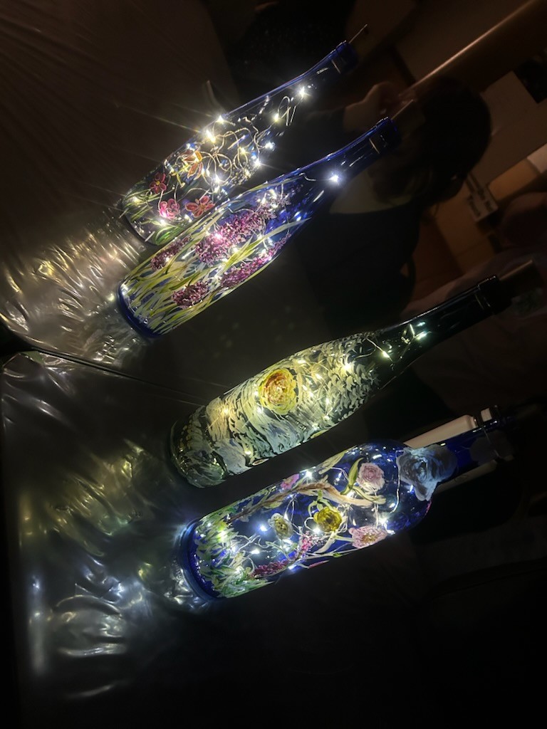 Third set of blue painted bottles in various designs with lights